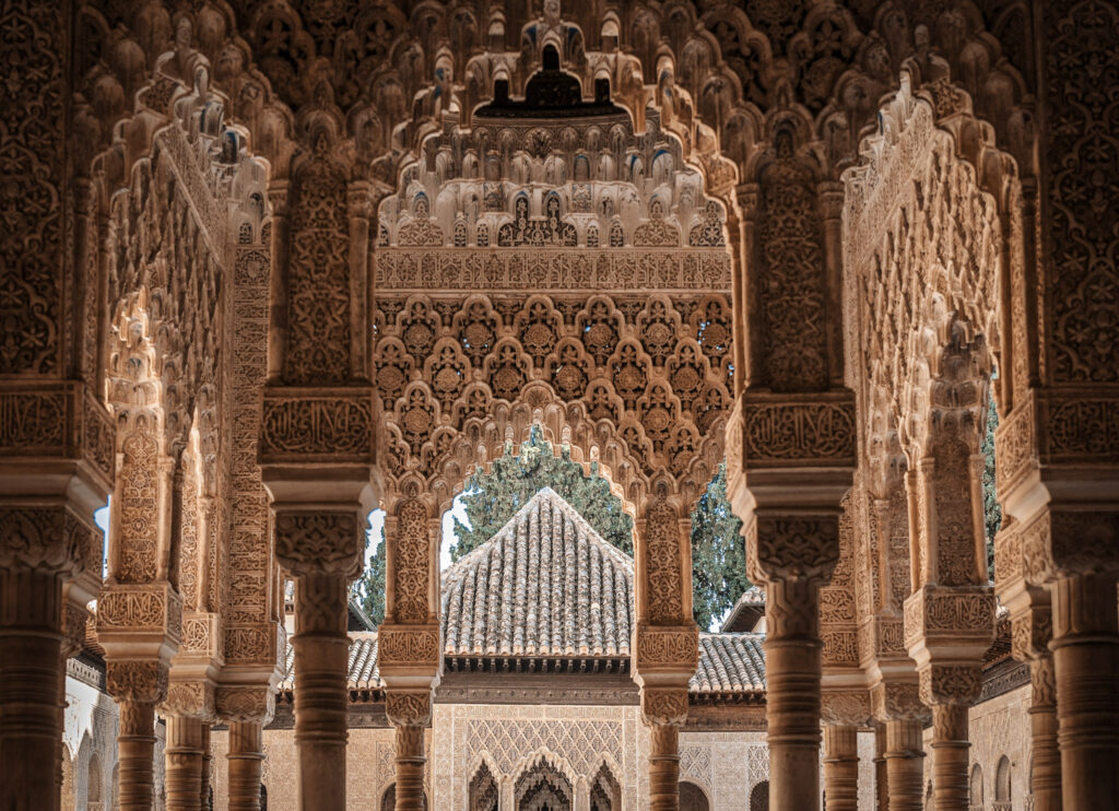 Intricate Moorish arches and carvings in the Alhambra's Nasrid Palaces, Granada