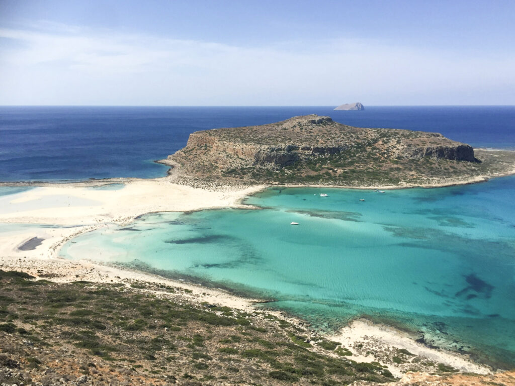 10 Trendy Beaches in Europe for 2026 Pink-tinted sand and turquoise lagoon at Elafonissi Beach, Crete