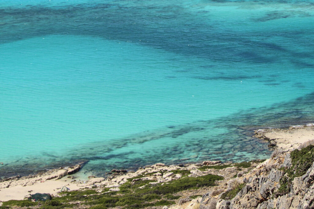 Best 10 Beaches in Crete, Greece Bright turquoise water and golden sand at Falassarna Beach, Crete