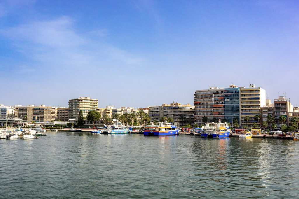 Santa Pola marina with fishing boats and waterfront buildings