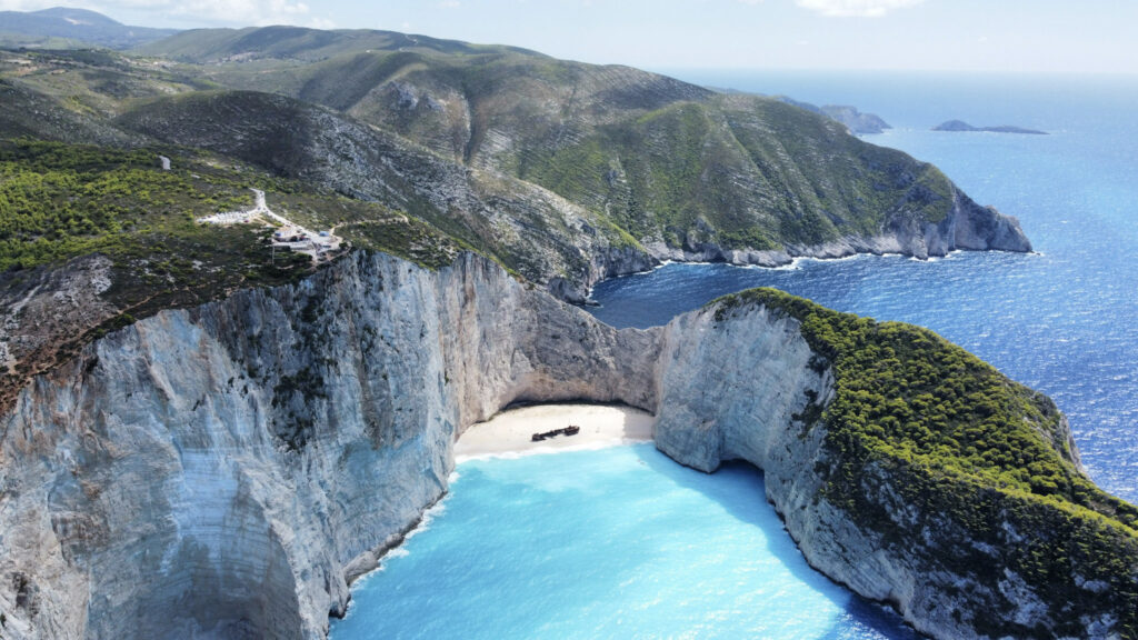 10 Trendy Beaches in Europe for 2026 Navagio Beach shipwreck cove surrounded by white cliffs in Zakynthos, Greece