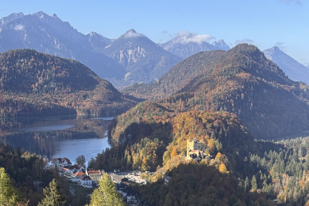 3 Days in Bavaria, Germany Hohenschwangau Castle and Alpsee lake surrounded by autumn mountains in Bavaria Germany