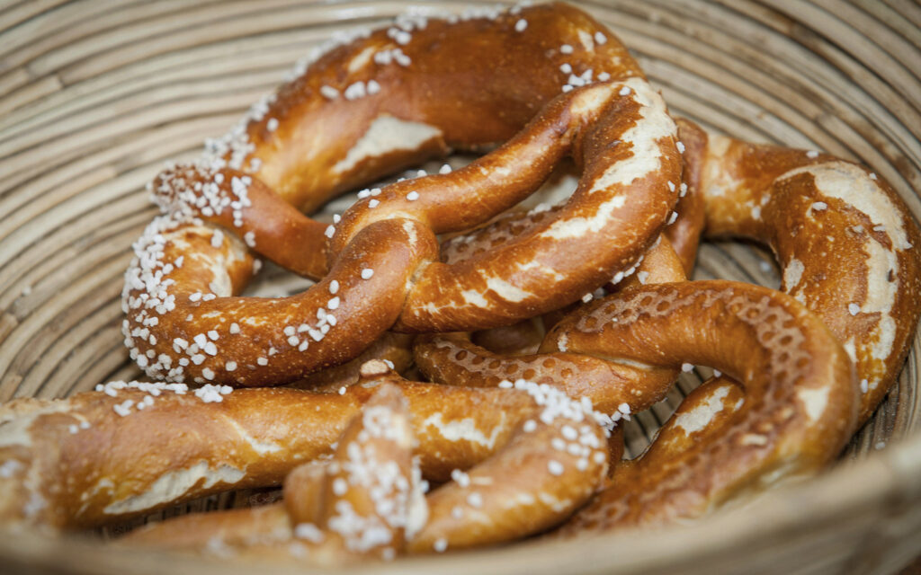3 Days in Bavaria, Germany Freshly baked traditional Bavarian Brezn pretzels sprinkled with coarse salt in a wicker basket