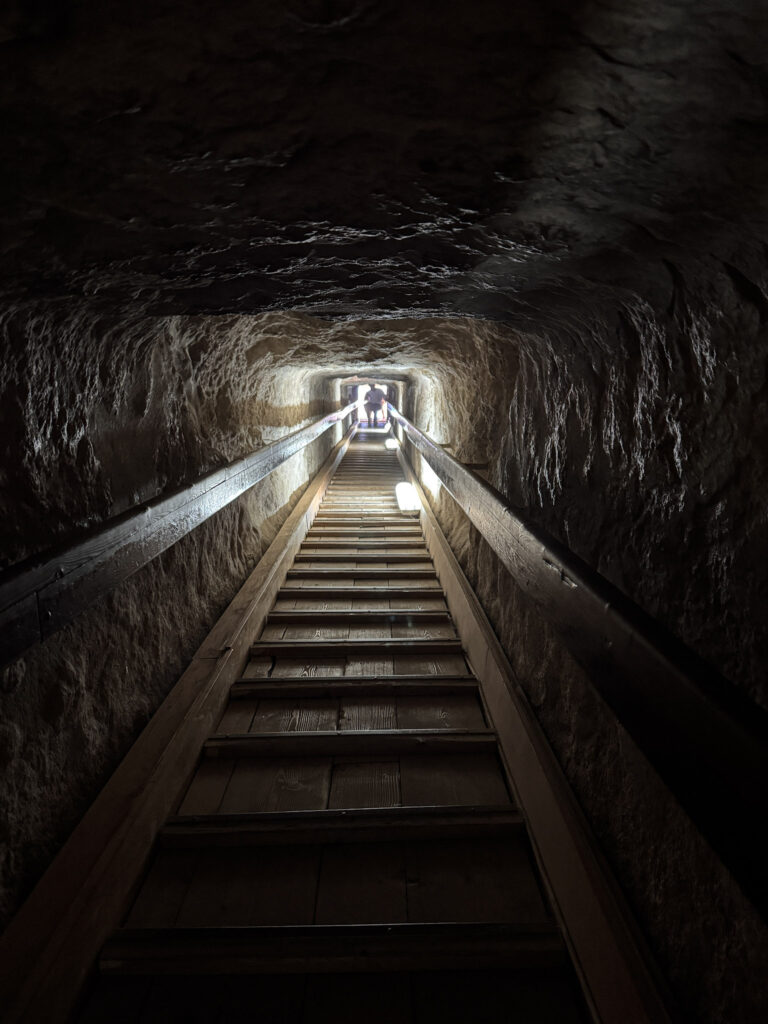 3 Days in Cairo, Egypt A narrow wooden ramp and stairs climbing up a steep stone passage tunnel inside the Great Pyramid of Giza