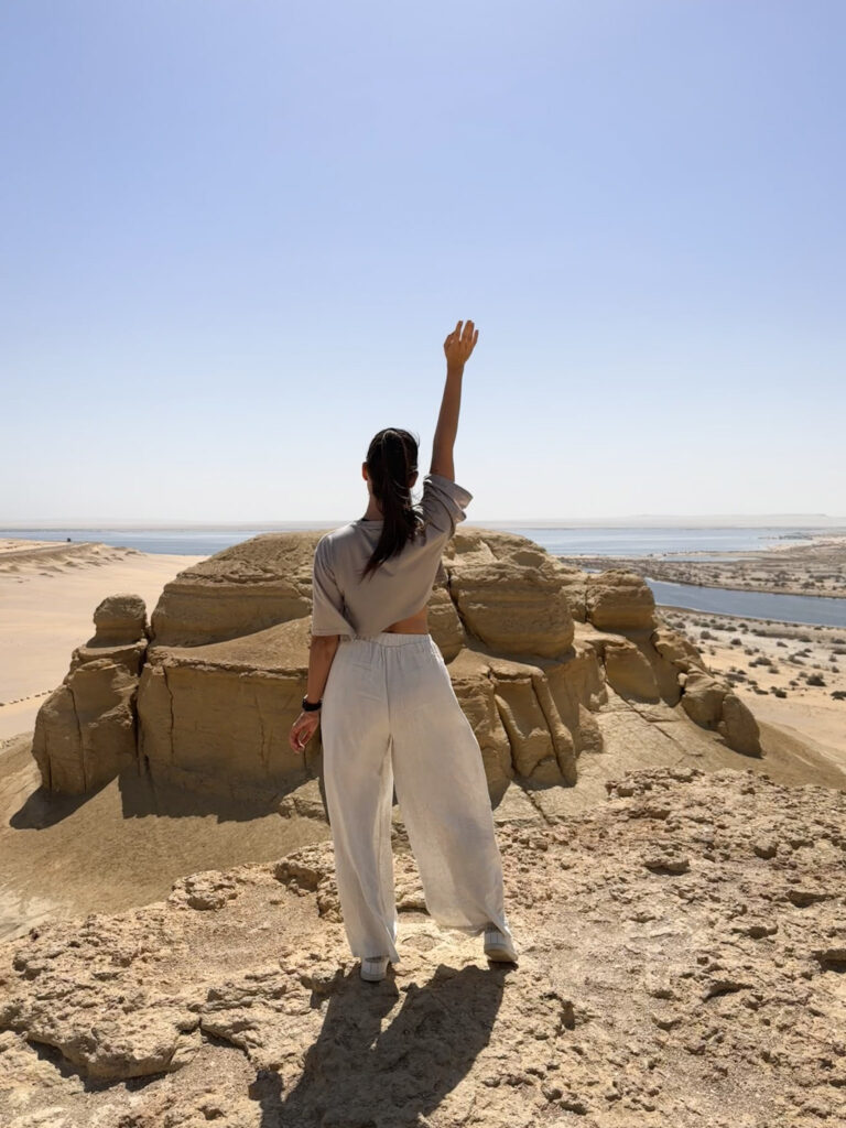 3 Days in Cairo, Egypt Reaching the summit of Jabal El Medawara to find an endless view of golden dunes meeting the bright blue waters of Magic Lake