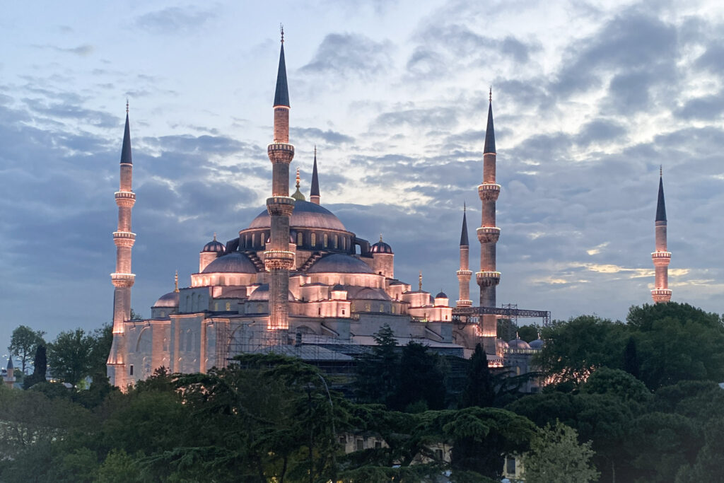 3 Days in Istanbul, Turkey The Blue Mosque in Istanbul illuminated at dusk against a cloudy sunset sky