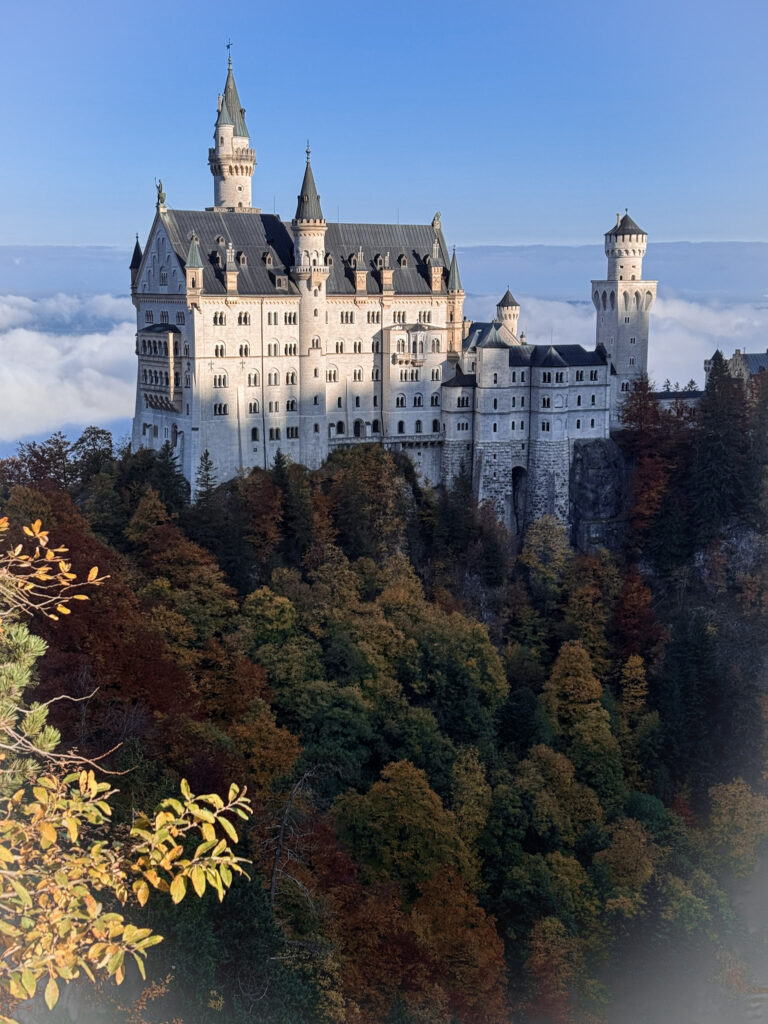 3 Days in Bavaria, Germany Neuschwanstein Castle in Germany soaring above thick low fog and autumn forests