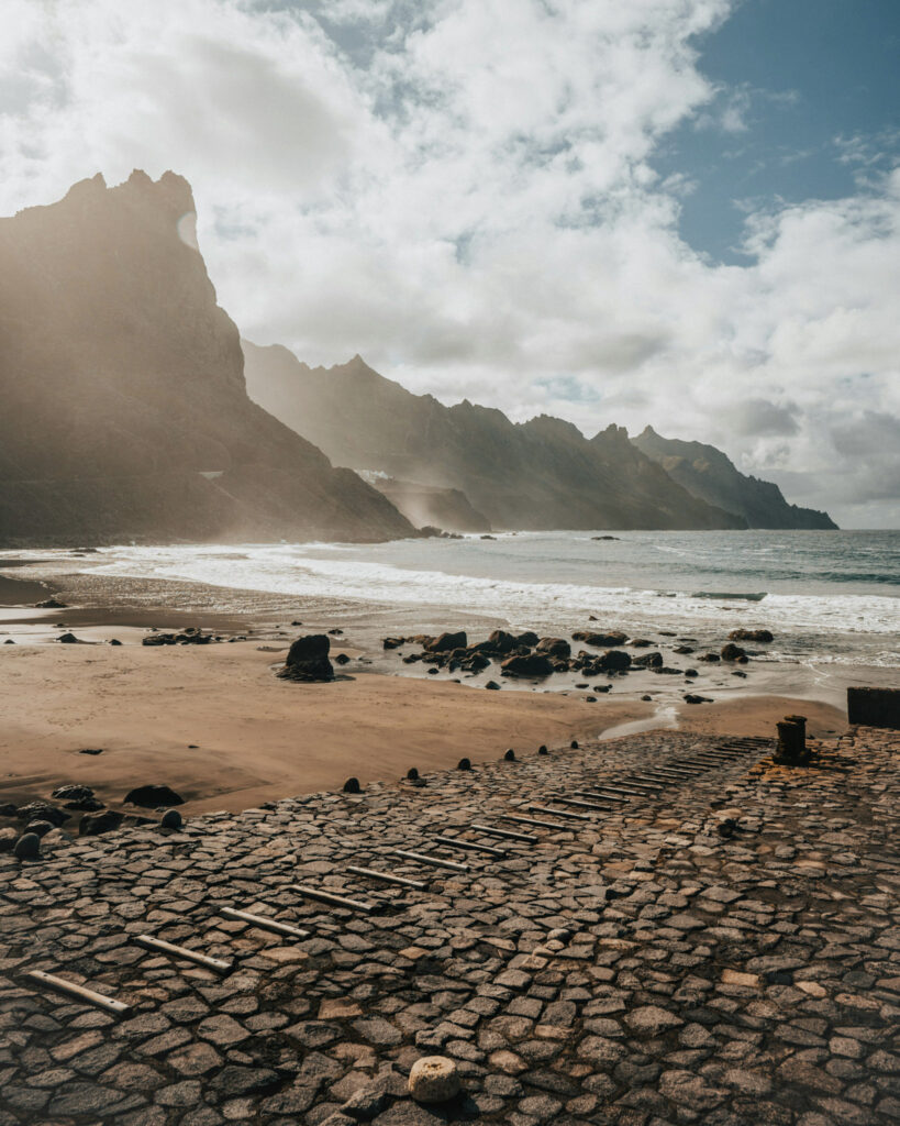 Top 10 Beaches in Tenerife Ocean waves rolling onto the dark volcanic sand of Playa del Roque de las Bodegas in northern Tenerife