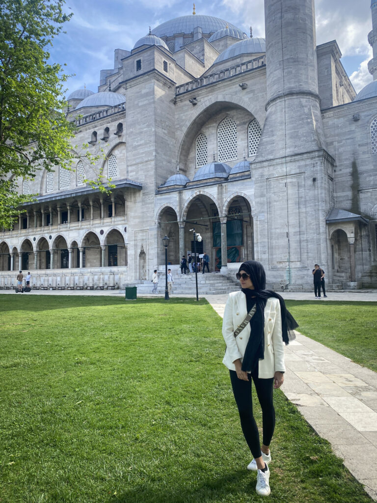3 Days in Istanbul, Turkey A travel blogger exploring the courtyard of Suleymaniye Camii in a respectful mosque outfit dress code