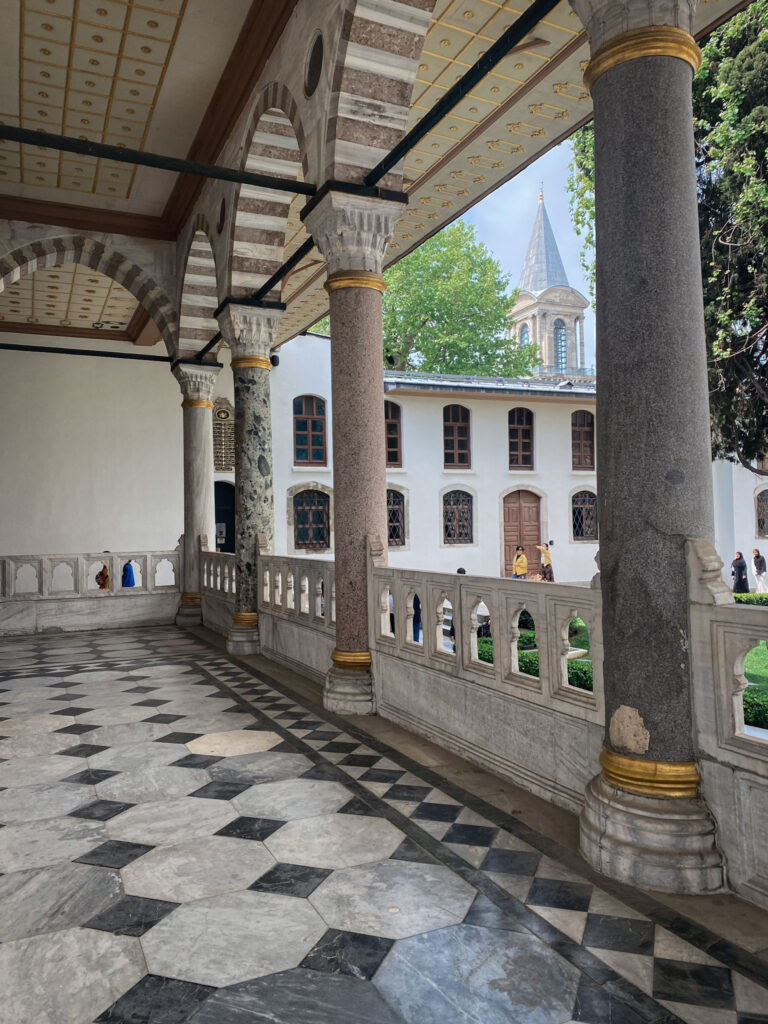 3 Days in Istanbul, Turkey A marble columned portico arcade at Topkapi Palace in Istanbul looking towards the Tower of Justice under a blue sky