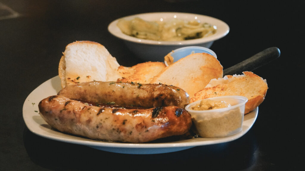 3 Days in Bavaria, Germany Traditional grilled German Bratwurst sausages served on a plate with crusty rolls and mustard