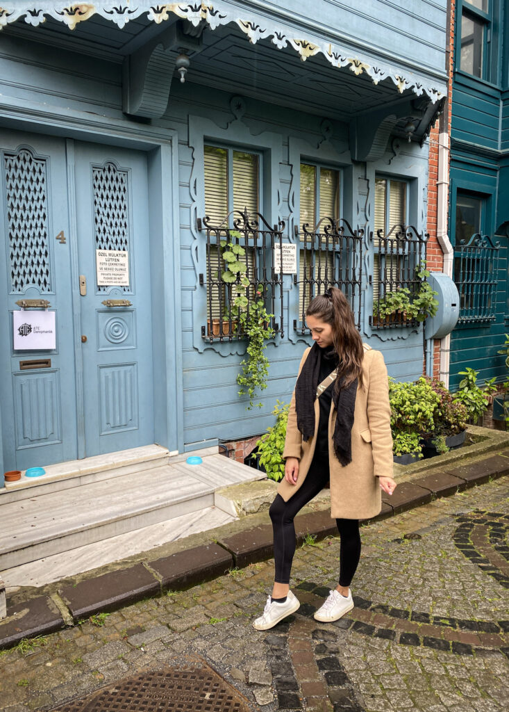 3 Days in Istanbul, Turkey Jet Lag Jelly creator posing outside a historic blue wooden house in Kuzguncuk Istanbul