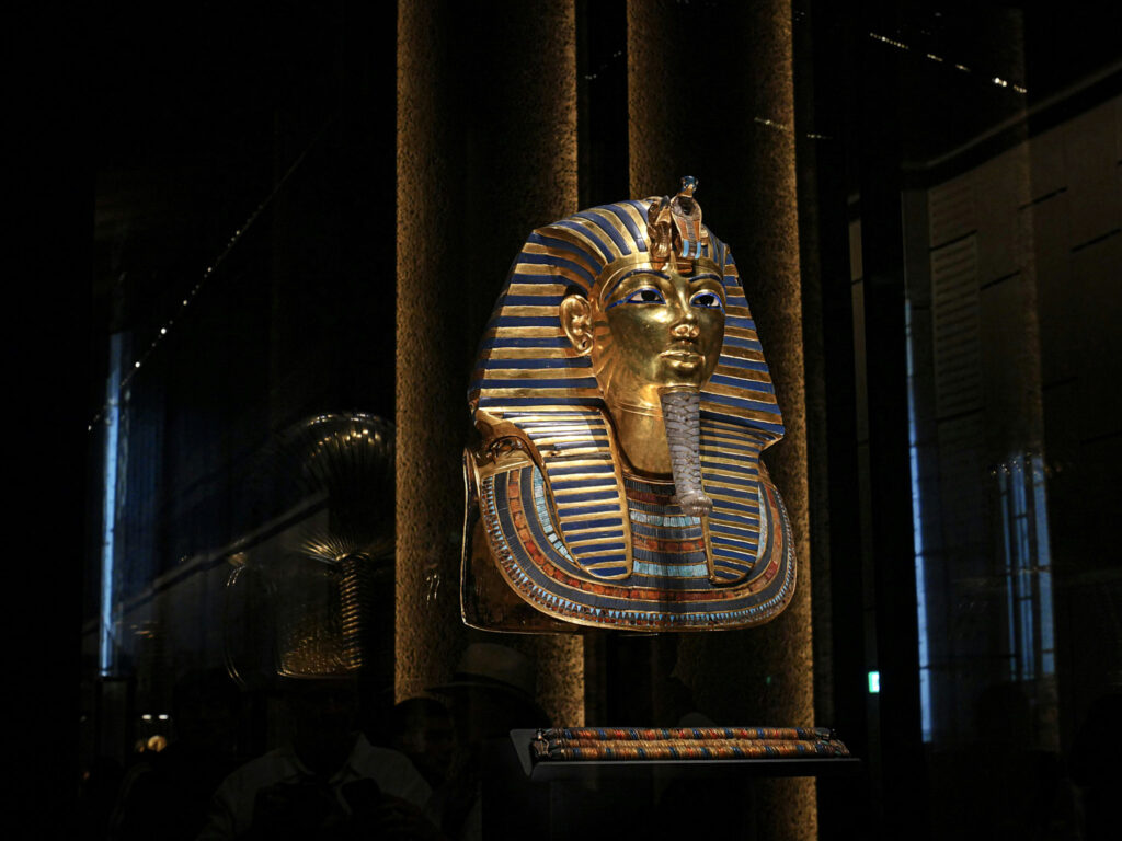 3 Days in Cairo, Egypt The ancient gold Mask of Tutankhamun inlaid with semi-precious stones displayed inside a museum glass case in Cairo, Egypt