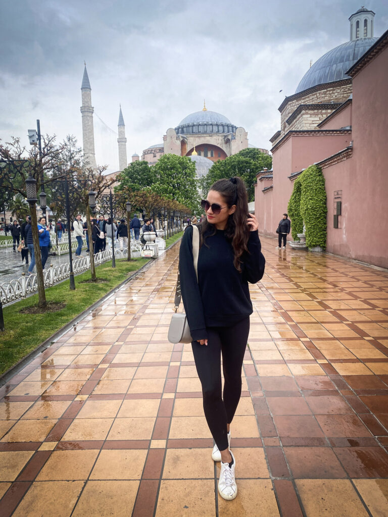 3 Days in Istanbul, Turkey Jet Lag Jelly creator standing in Sultanahmet Square with Hagia Sophia mosque in the background on a cloudy day