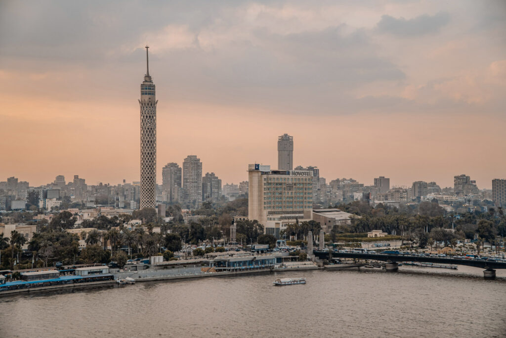3 Days in Cairo, Egypt The Cairo Tower standing tall over the Nile River and city skyline during a hazy sunset in Cairo, Egypt