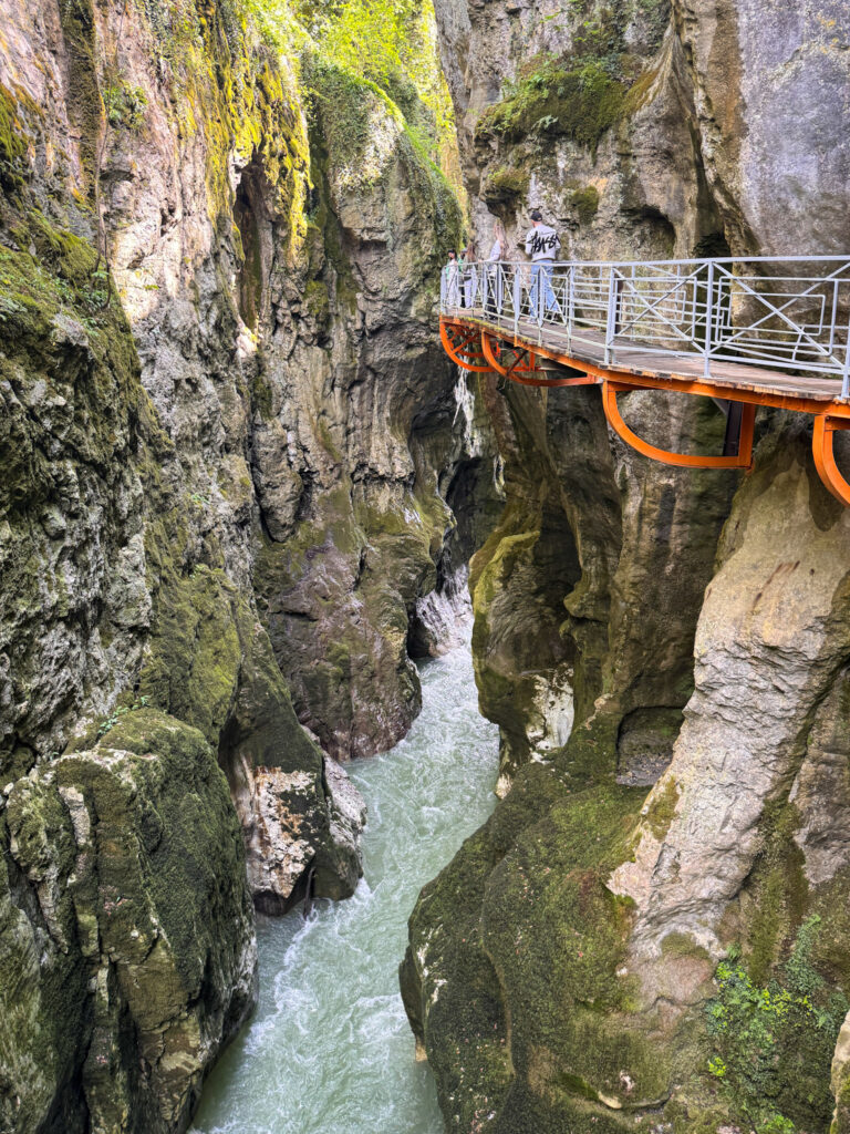 Top 10 Places in Southeastern France Suspended footbridge walkway over the rushing river inside the historic Gorges du Fier canyon in France