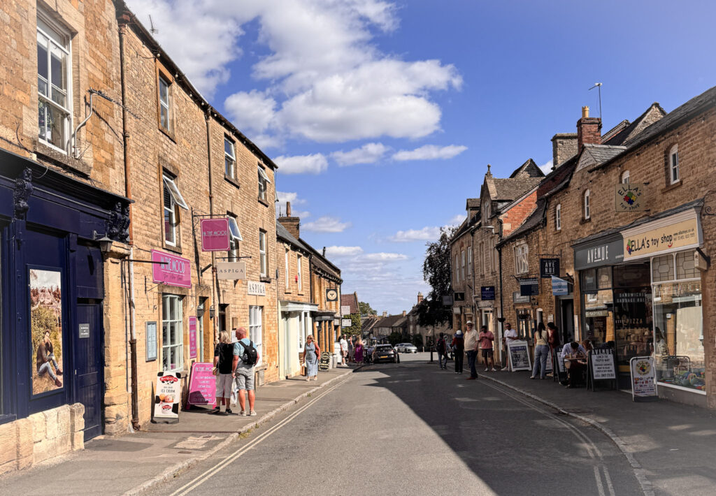 Top 5 Villages in the Cotswolds Shoppers walking along Digbeth Street past Ella's Toy Shop and The Nook boutique in Stow-on-the-Wold, the Cotswolds.